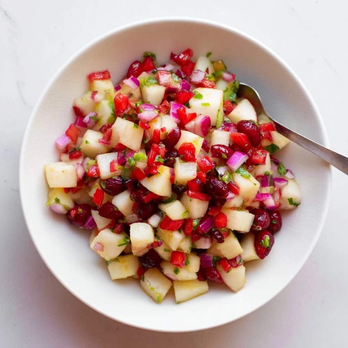 Fresh pear and cranberry jalapeño salsa, bursting with flavors for your next party.