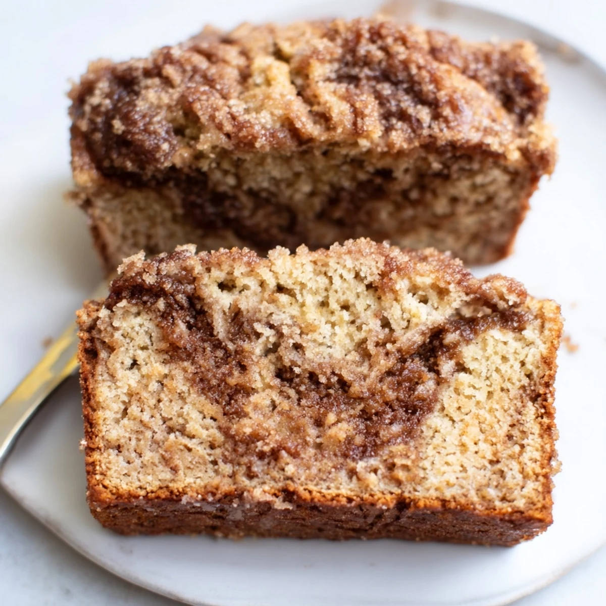 Chai Spice Muffin Loaf adorned with crunchy sugar topping and inviting aroma.
