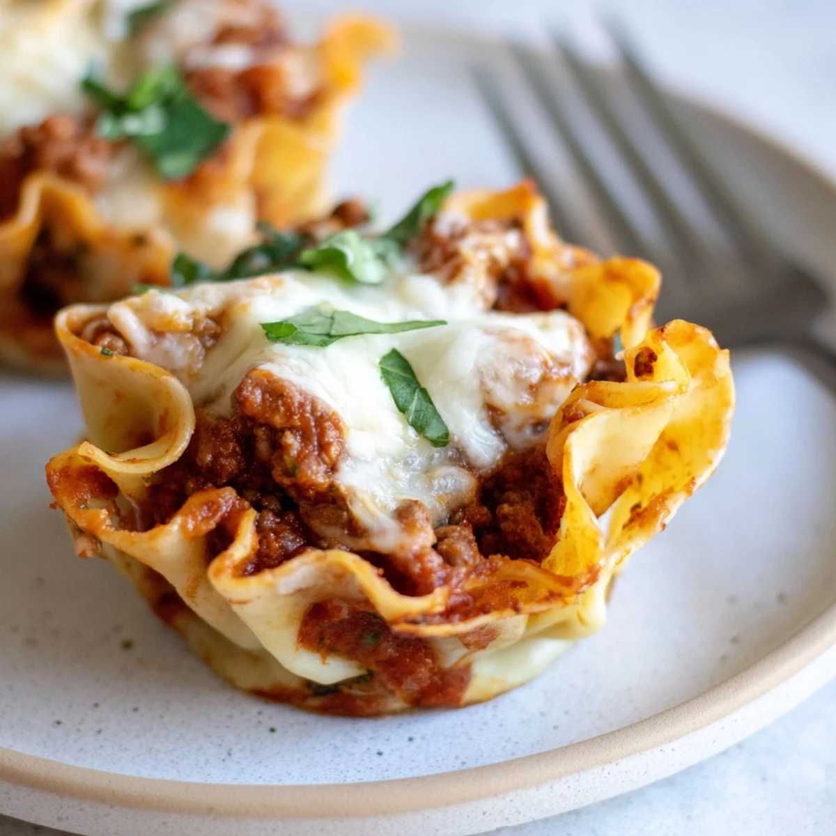 Delicious lasagne soup-free pasta cups topped with melted cheese, perfect for gatherings.