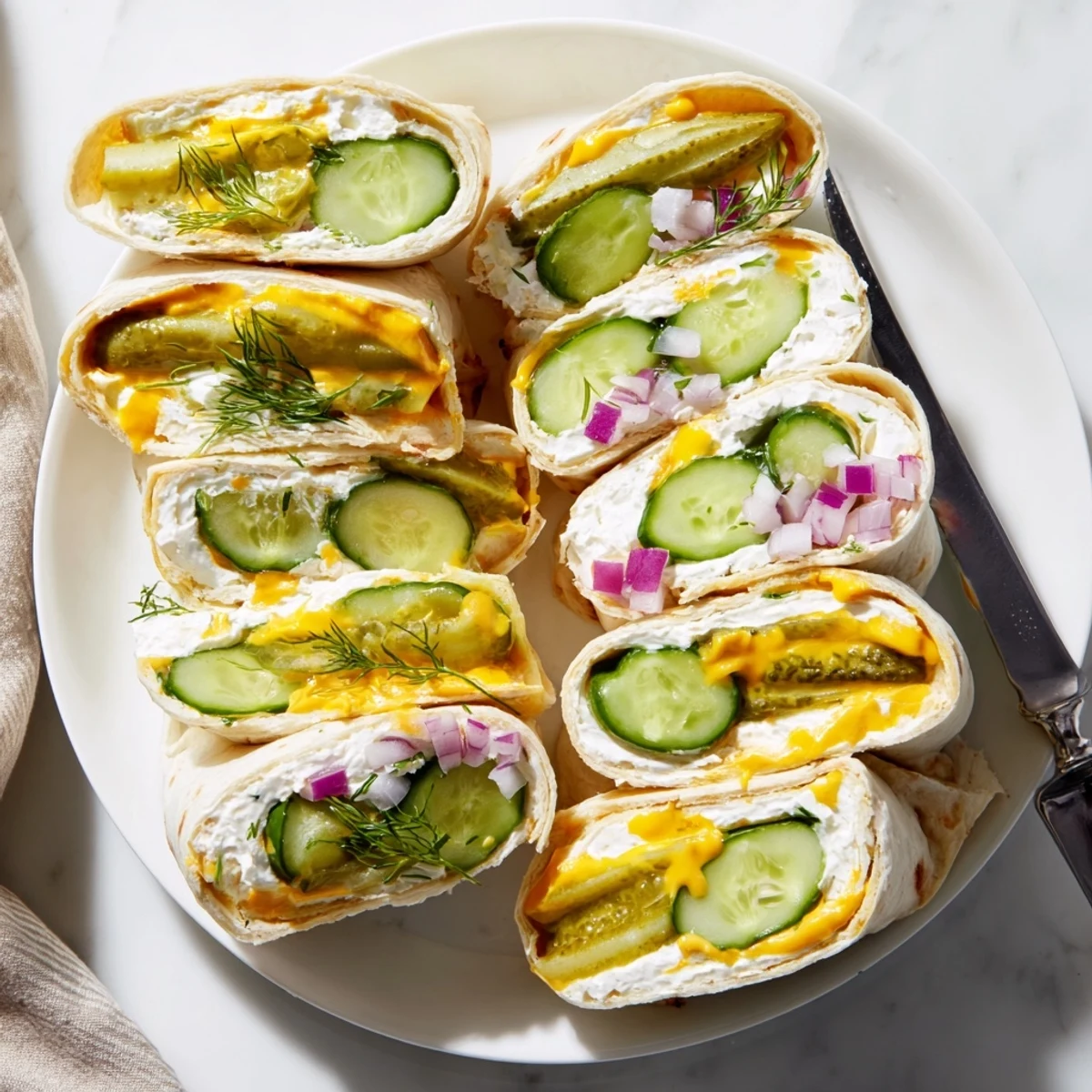 Crisp pickles wrapped in tortillas, savory cream cheese, ideal for snacking.  