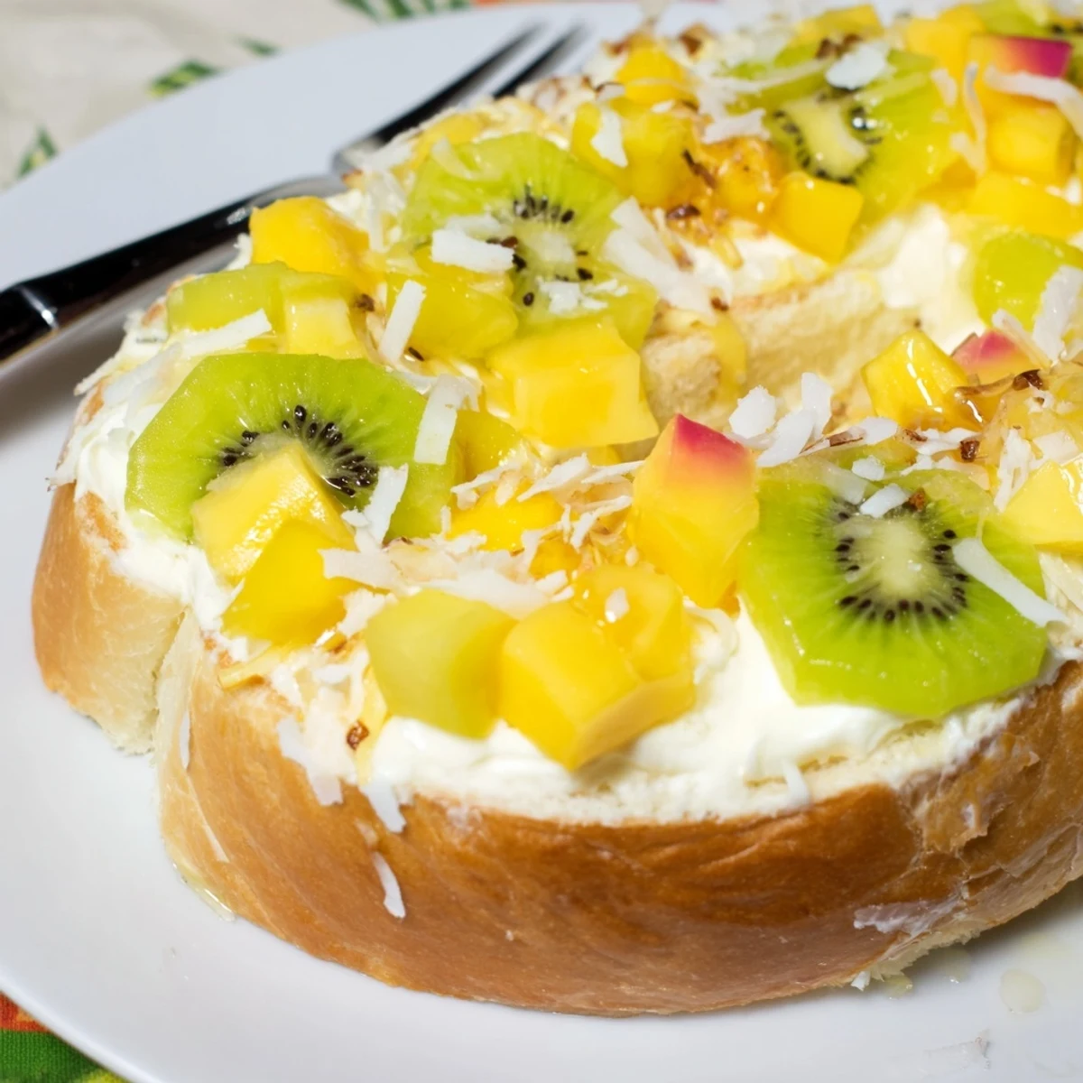 Creamy yogurt-custard toast topped with fresh tropical fruits and coconut delight.  