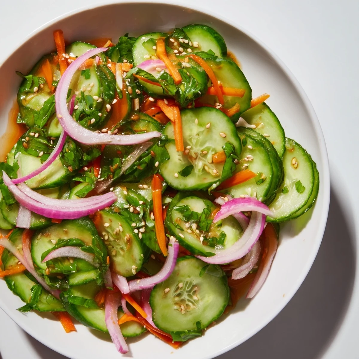 Refreshing cucumber salad remix with vibrant colors and Asian-inspired seasonings.  