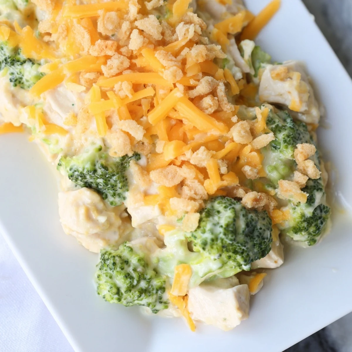 Golden, bubbly Chicken & Broccoli Cheddar Bake, revealing a creamy, cheesy, family-friendly dinner.