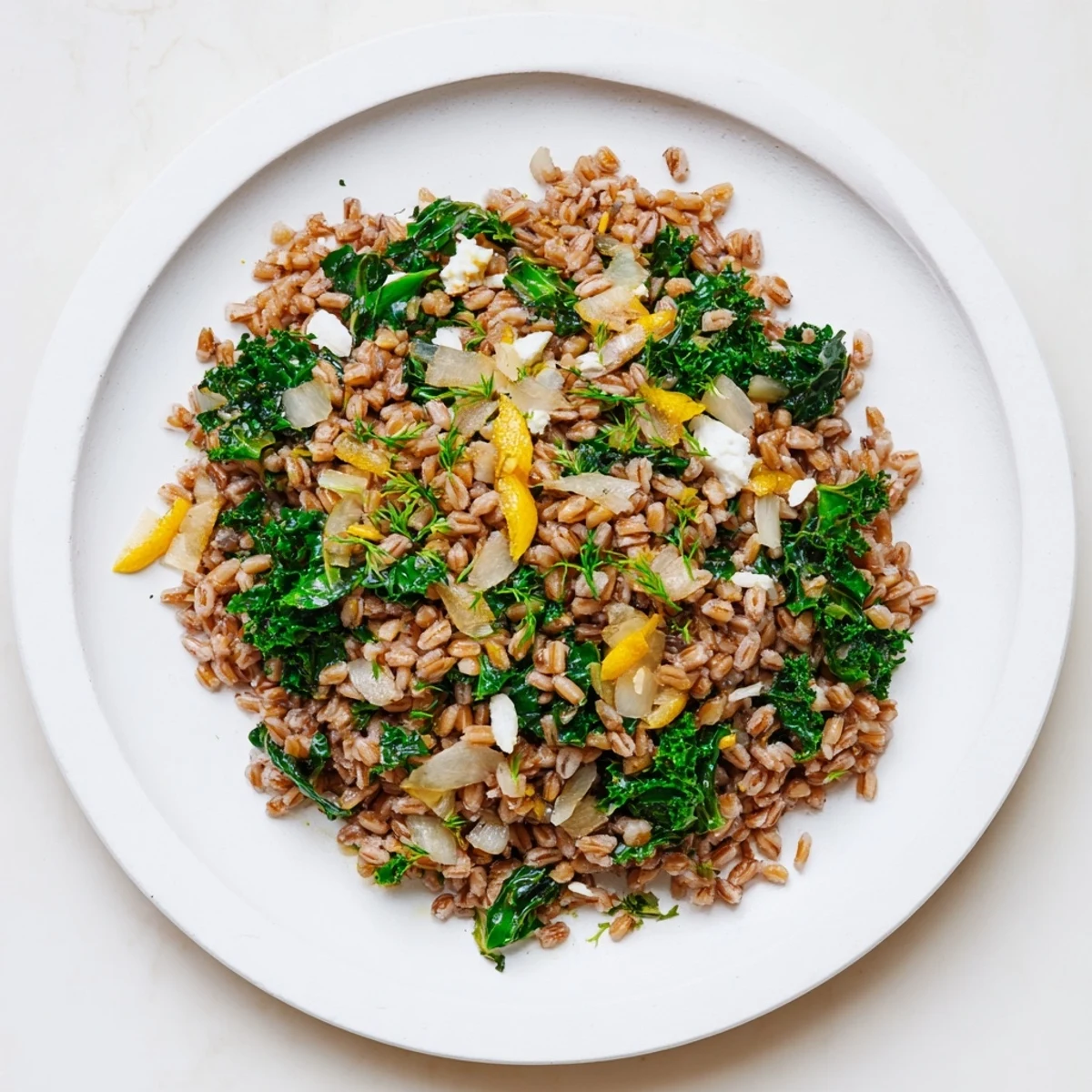 A flavorful Warm Farro & Greens Pilaf, topped with toasted almonds and fresh parsley, ready to eat.