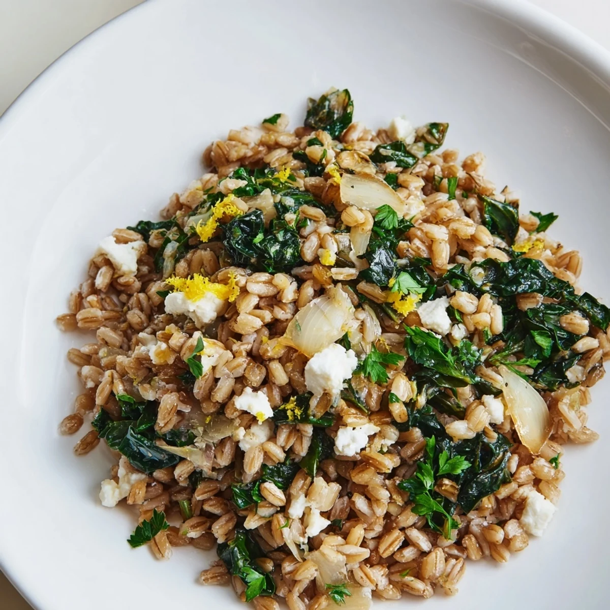 Close-up of a steaming Warm Farro & Greens Pilaf; the farro and almonds offer great textures.