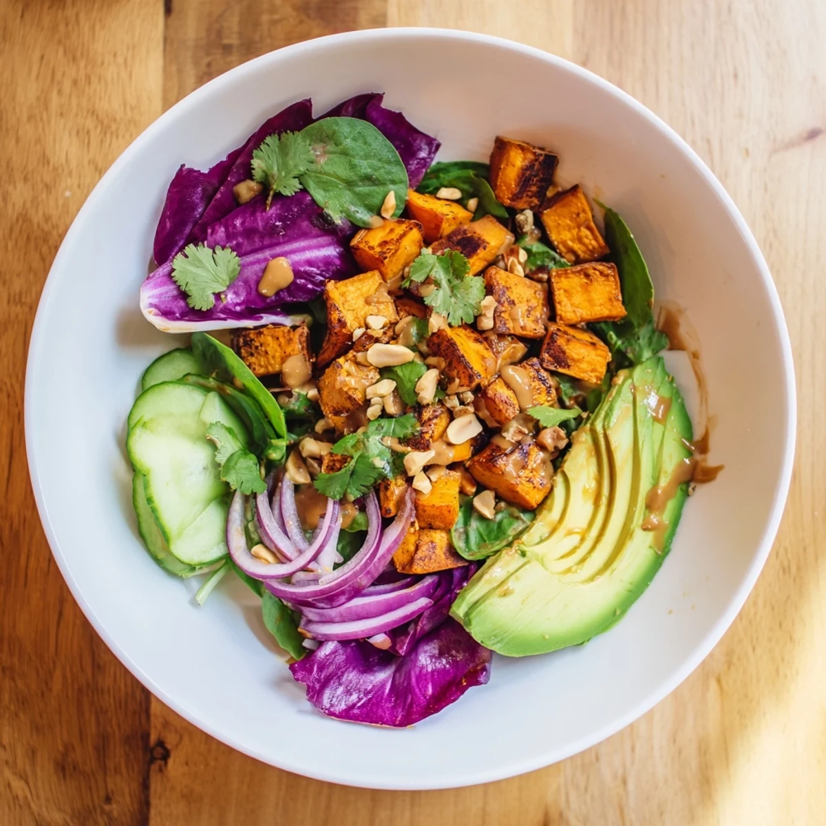 This Spiced Peanut Sweet Potato & Radicchio Salad Bowl features tender sweet potatoes, creamy avocado, and a zesty peanut dressing.