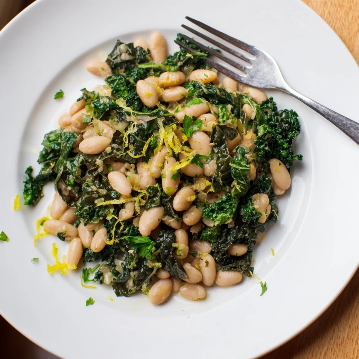 Rustic plate of Garlicky Beans with Winter Greens, a comforting vegetarian dish ready to be served.
