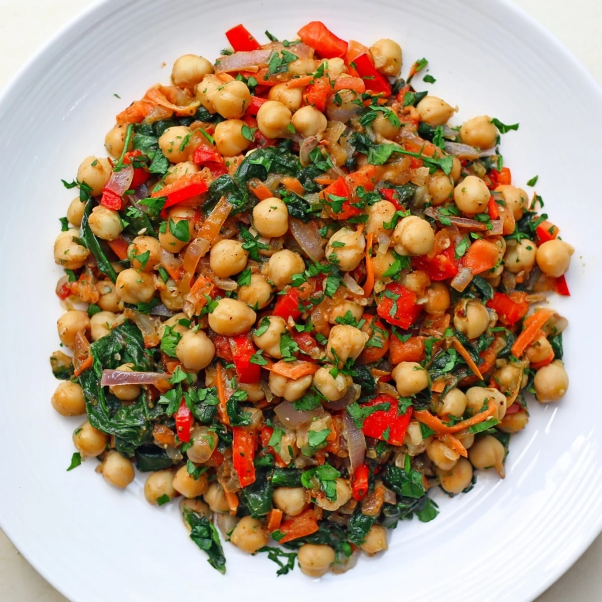 Savory Vegetarian Chickpea & Spinach Skillet with glistening chickpeas, fresh spinach, and rich spices.