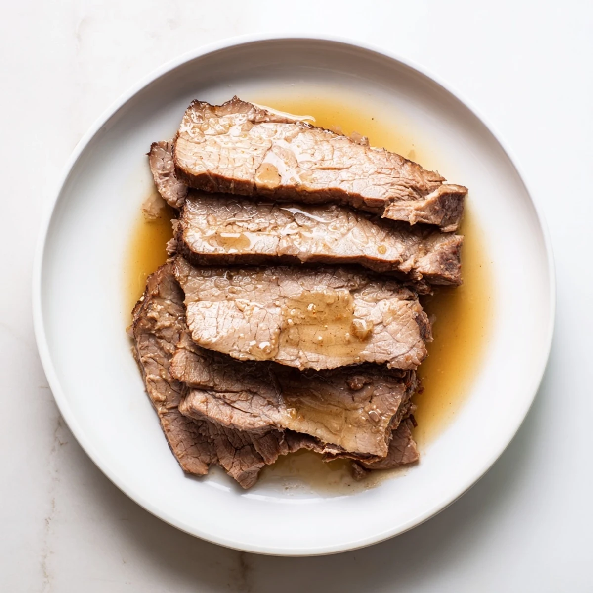 Tender Budget Holiday Chuck Roast, falling apart, with savory juices perfect for a gluten-free main course.