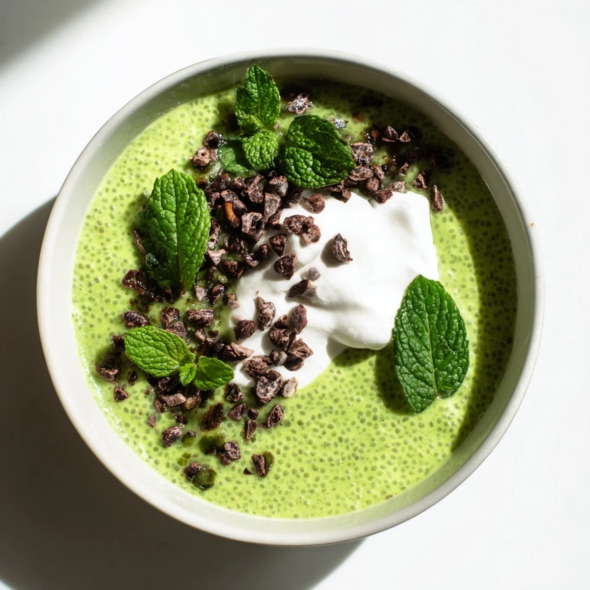 A refreshing swirl of green Grinch Mint Matcha Chia Pudding, perfect for a healthy vegan breakfast.