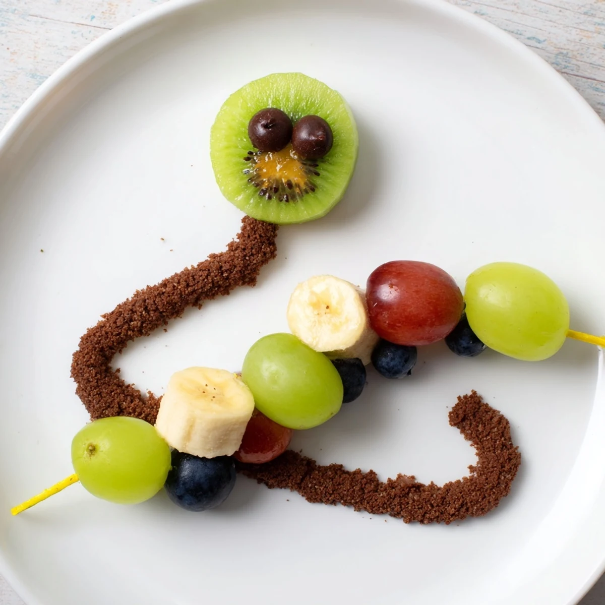 Close-up of a delightful Caterpillar Fruit Skewer Track, a healthy and fun fruit-based dessert option.