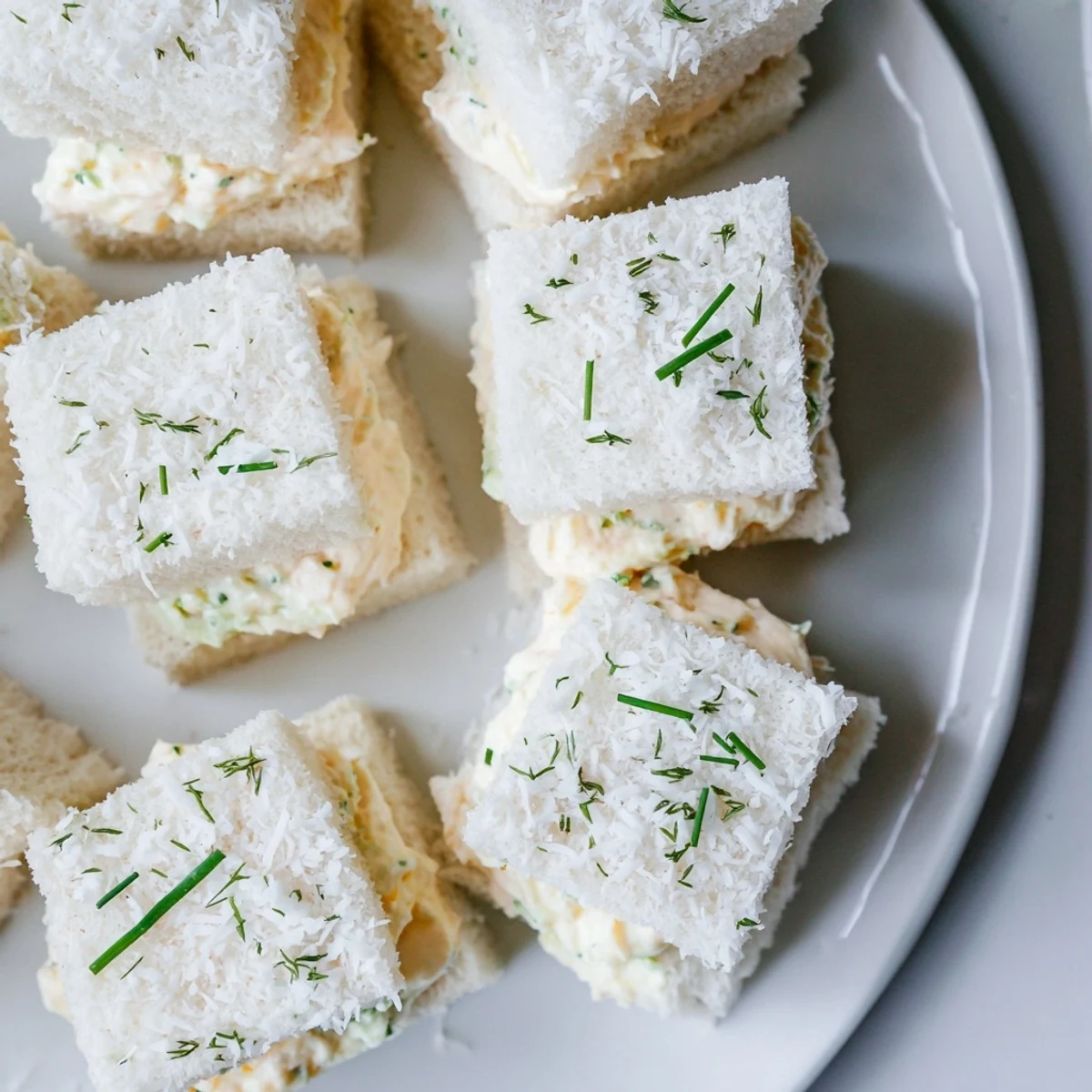 Fluffy Snowball Tea Sandwich Bites, rolled in coconut, perfect for an elegant afternoon tea.