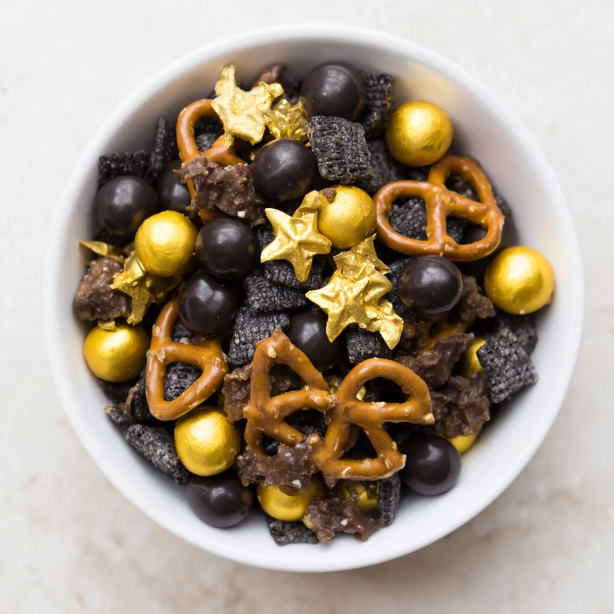 Golden and black Midnight Snack Mix, a crunchy, sweet-savory party snack ready for serving.