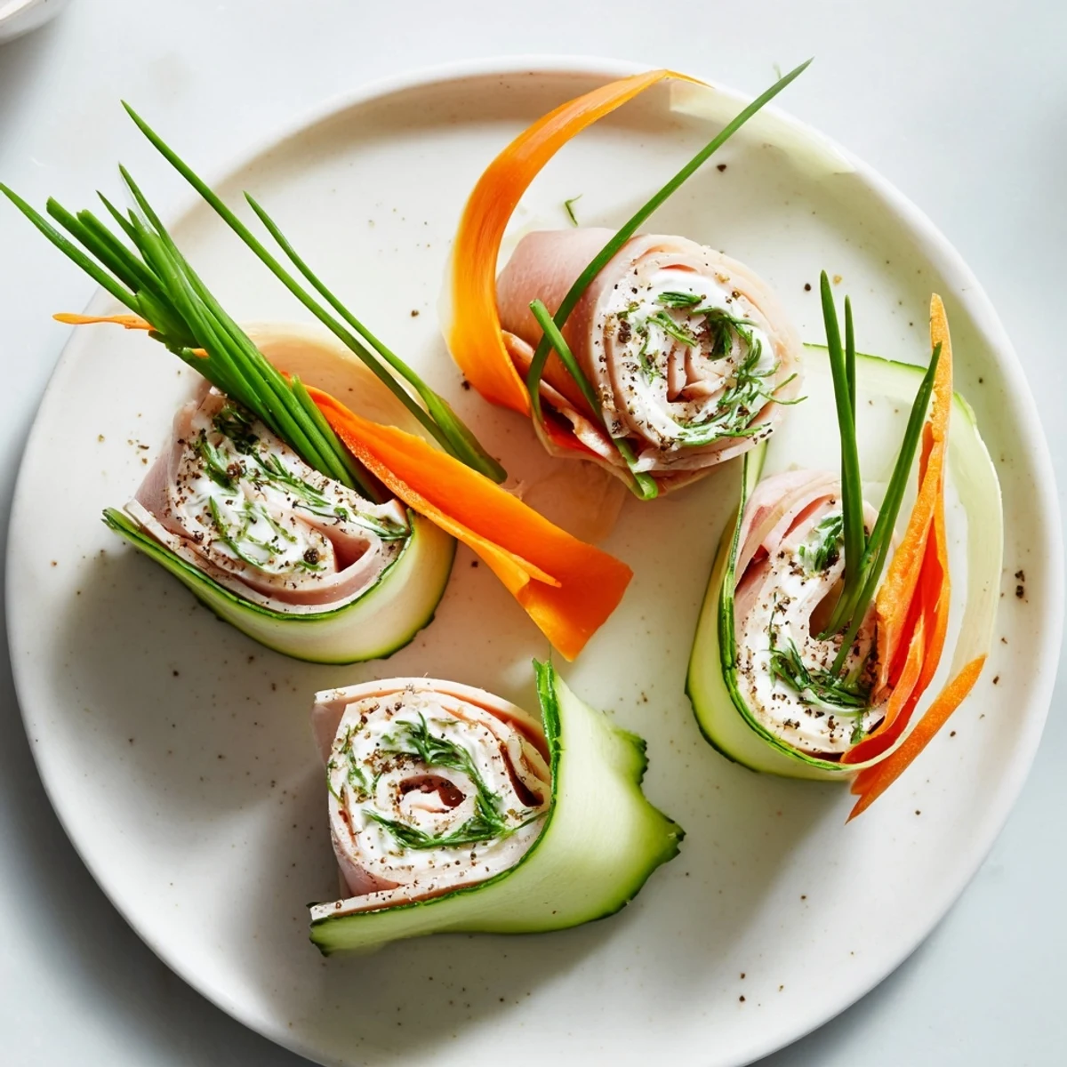 Freshly made Ribbon Dancer appetizer with colorful carrot and cucumber ribbons around savory turkey.