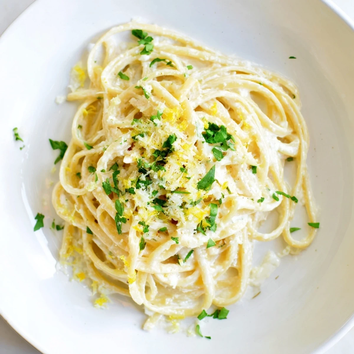 Creamy Lemon-Garlic Greek Yogurt Pasta, ready to eat, topped with fresh parsley and Parmesan.