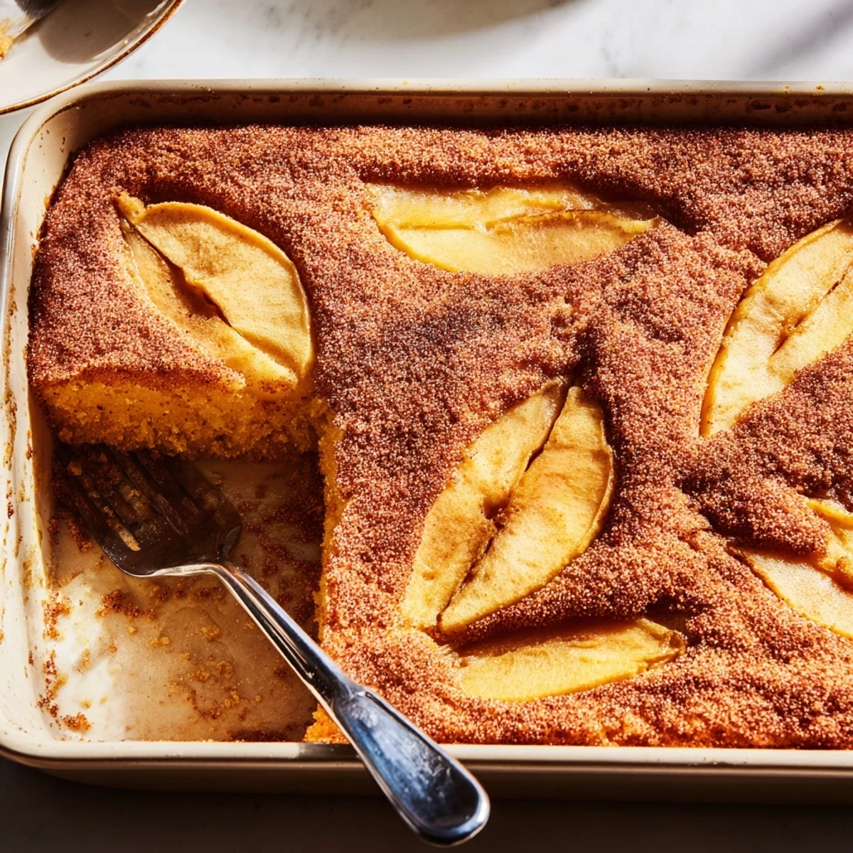 Golden Baked Apple Cake with cinnamon-spiced apple slices, fresh from the oven and served warm for a cozy breakfast.