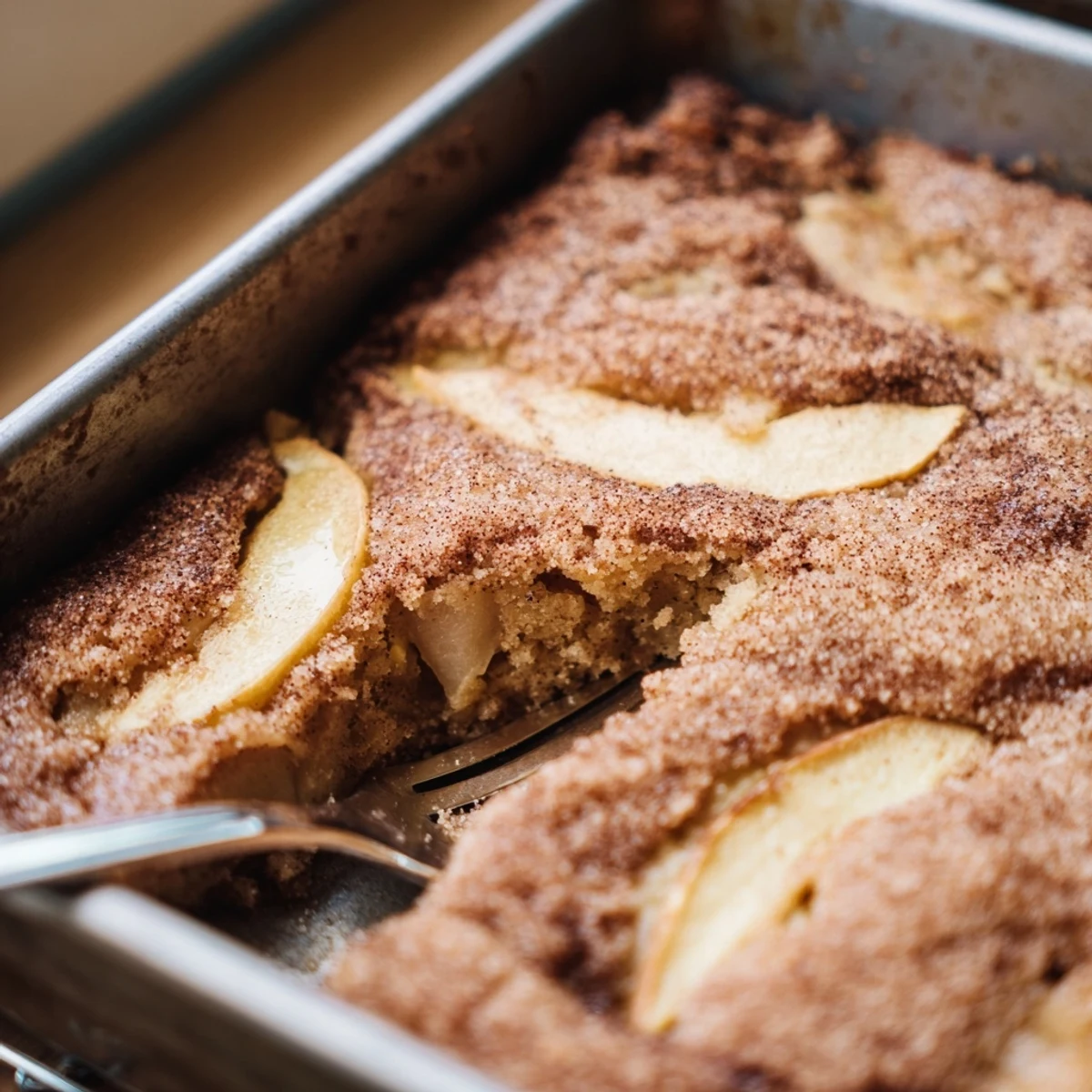 Sliced Baked Apple Cake showing tender apples baked into a soft, golden Dutch-inspired dessert, perfect with a cup of coffee.