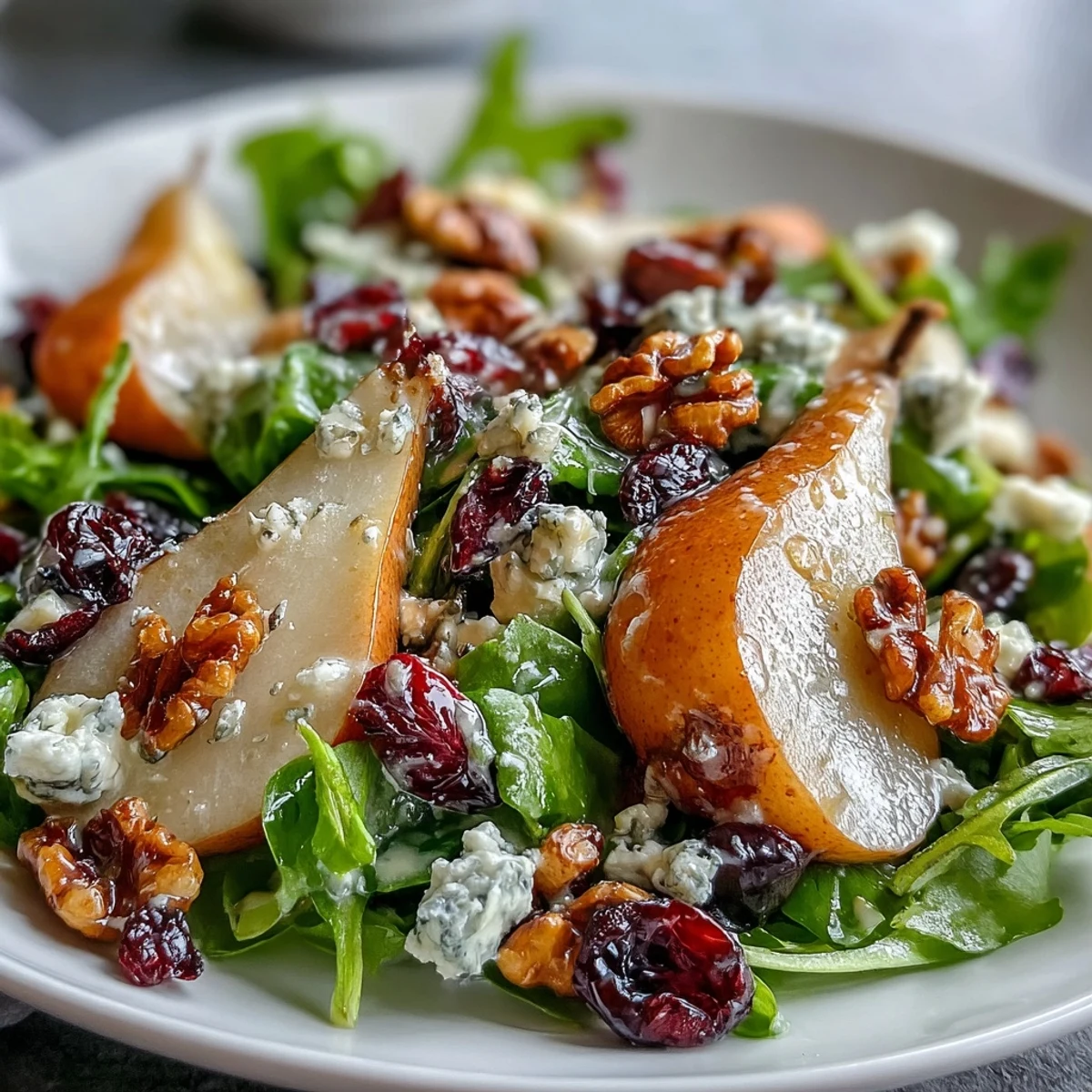 Freshly sliced ripe pears and crumbled Gorgonzola cheese top a vibrant bed of mixed greens with toasted walnuts, drizzled with honey-balsamic vinaigrette.  