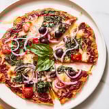 Perfectly melted mozzarella and vibrant toppings star in this crispy tortilla pizza shot.