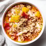 Hearty Italian Pizza Soup featuring sausage, vegetables, and creamy melted cheese.