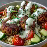 This wholesome vegetarian Falafel Quinoa Salad Bowl features crisp chickpea fritters, fresh vegetables, and a tangy lemon-tahini dressing, served as a healthy, gluten-free main dish.