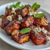 Sweet and smoky Grilled Watermelon Salad with Feta and Mint, served with arugula and balsamic glaze for a refreshing vegetarian dish.