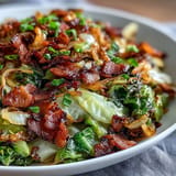 Tender sautéed cabbage, smoky bacon, and sweet onions pictured steaming hot.