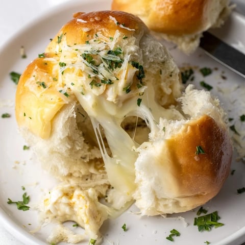 Soft, cheesy stuffed dinner rolls, golden and fluffy, perfect for dipping or snacking.  