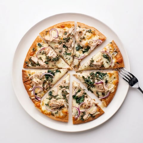 Sage Turkey Gravy Pizza topped with melty cheese and savory turkey, perfect for leftovers.  
