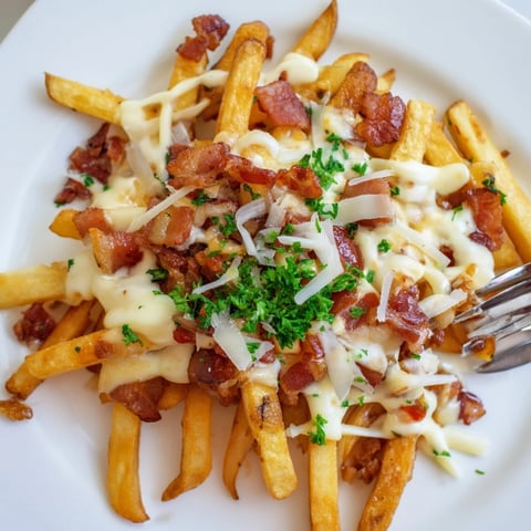 Crispy truffle oil loaded fries bake topped with melted cheese and savory bacon.  