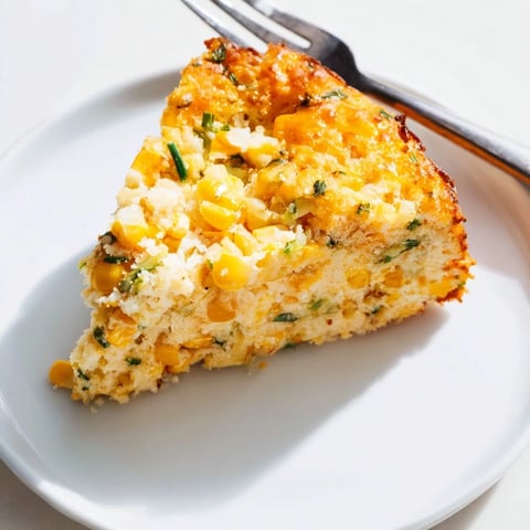 A golden Cheddar Corn Chaos Cake loaded with cheddar and sweet corn delights.  