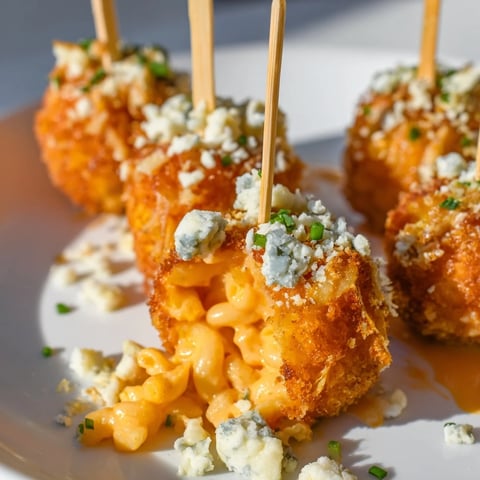 Creamy Spicy Buffalo Pumpkin Mac Pops served on sticks, perfect for cozy gatherings.  