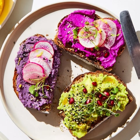 Vibrant Bright & Bold Breakfast Toasts topped with ube, avocado, and fresh herbs.