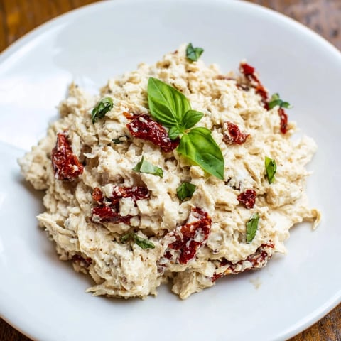 Creamy, savory Lightened Marry Me Chicken Dip, bubbling hot with melted cheese and fresh herbs.