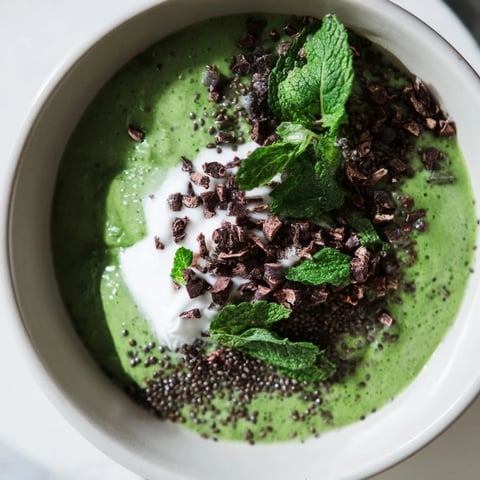 Vibrant Grinch Green Mint Matcha Chia Pudding, topped with yogurt and cacao nibs, ready to enjoy.
