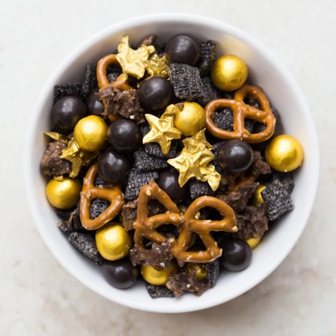 Golden and black Midnight Snack Mix, a crunchy, sweet-savory party snack ready for serving.