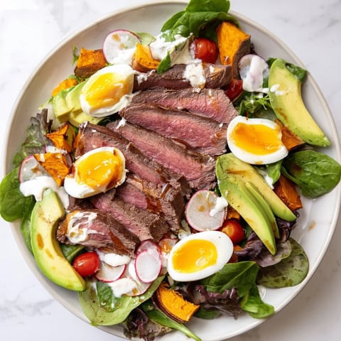 Steaming slices of beef in this protein-packed Beef Avocado Bowl look perfectly seasoned with creamy avocado.