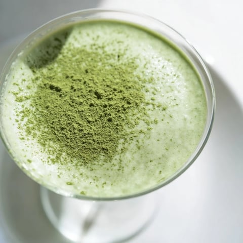 A chilled Matcha Martini cocktail, creamy and green, garnished for an elegant presentation.