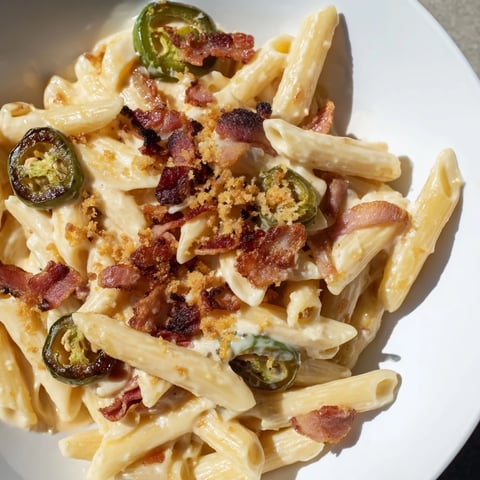 Creamy jalapeño popper pasta features roasted jalapeños and crispy bacon tossed in a rich, velvety cheese sauce.  