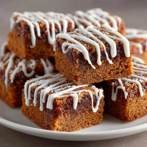 Festive picture of delicious Swedish Ginger Snap Cookie Bars, featuring a generous white chocolate zigzag pattern.