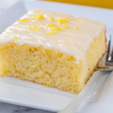 A vibrant lemon soda sheet cake topped with tangy glaze, perfect for parties.  