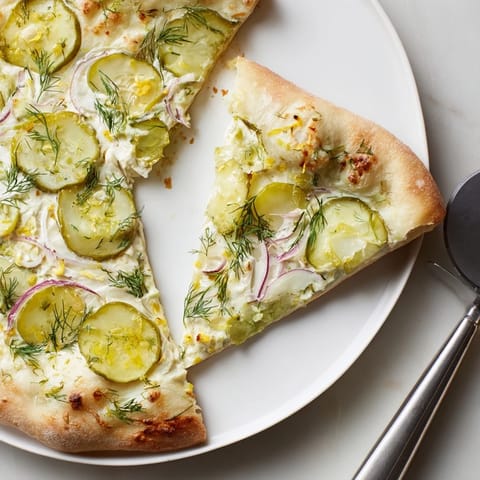 Savory Pickle Pizza with rich crème fraîche and crunchy dill pickles for a unique taste.  