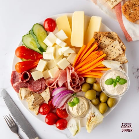 Stylish girl dinner platter loaded with delicious snacks, dips, and fresh fruits.  