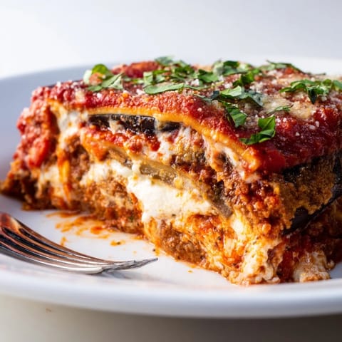 Layers of tender eggplant and creamy ricotta in Eggplant Parmesan Lasagna, perfect for dinner.  
