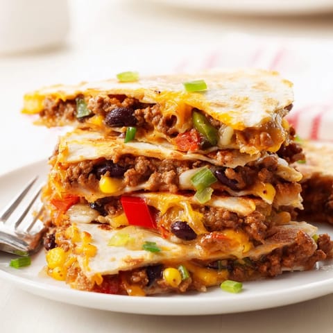 Golden, cheesy sheet pan quesadillas with beef, perfect for family gatherings and easy dinners.  