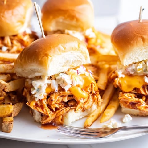 Tender shredded BBQ chicken on mini slider buns, paired with golden crispy fries.  