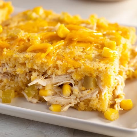 This image shows a freshly baked Southern Cornbread Chicken Casserole; imagine the tender chicken and sweet corn filling.