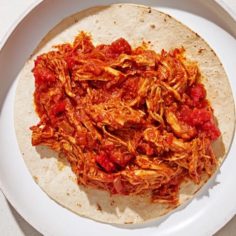 Savory Crock-Pot Shredded Chicken Tacos with juicy chicken and vibrant tomato sauce, perfect for family dinners.
