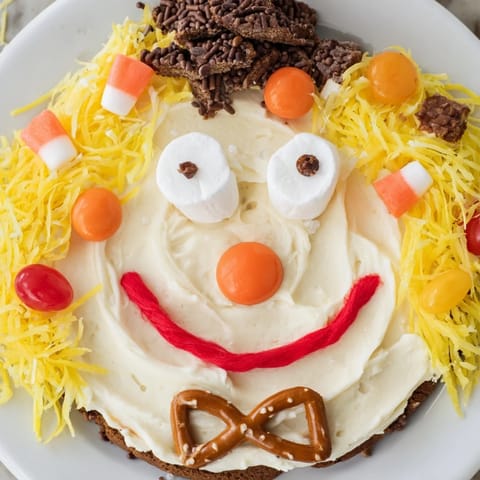 Vibrant Scarecrow Candy Platter with a smiling face, filled with colorful autumn candies for sharing.