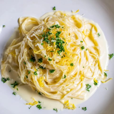A close-up of Lemon-Garlic Greek Yogurt Pasta, showcasing the creamy sauce with lemon zest.